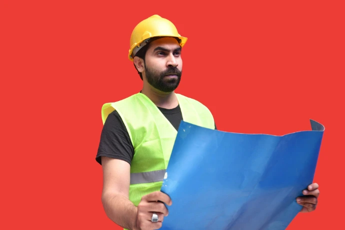 a man wearing a hard hat holding a blue and yellow flag